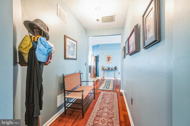 hall with hardwood / wood-style floors