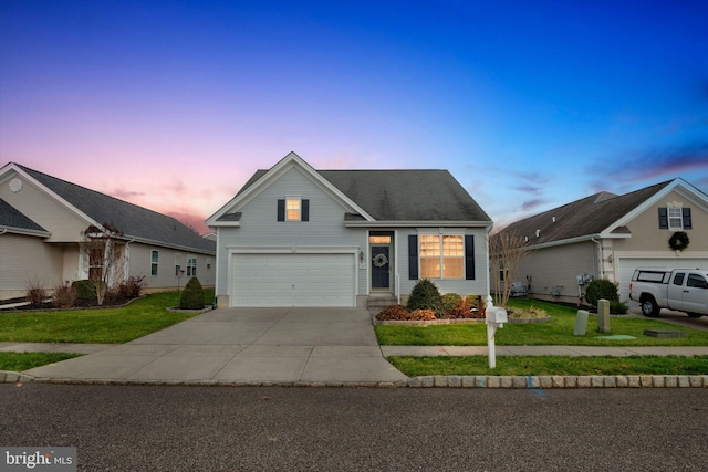 front facade with a garage and a lawn