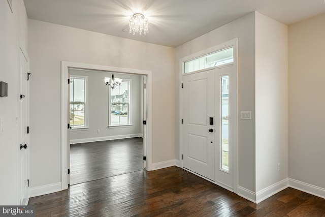 entryway featuring dark hardwood / wood-style flooring and an inviting chandelier