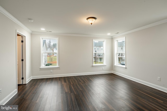 spare room featuring dark hardwood / wood-style floors and ornamental molding