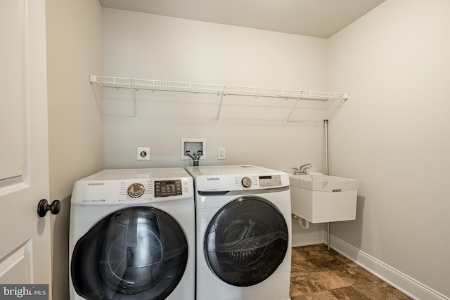 laundry room with sink and washing machine and clothes dryer