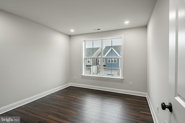 empty room with dark hardwood / wood-style flooring