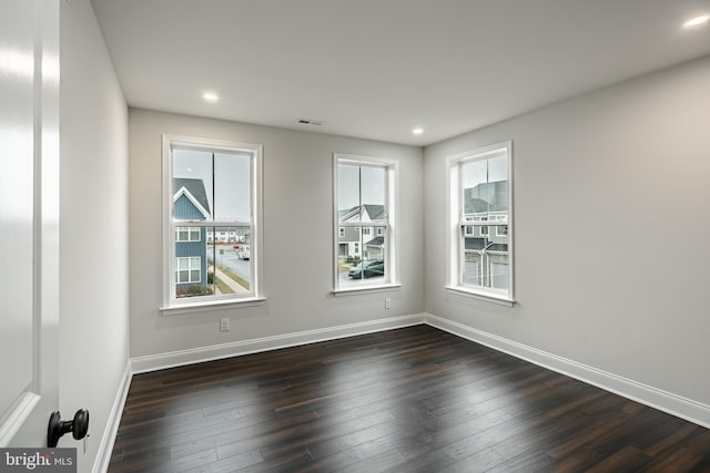 unfurnished room featuring dark hardwood / wood-style floors