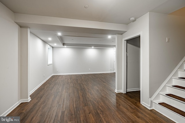 basement featuring dark hardwood / wood-style flooring