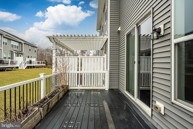 wooden deck with a pergola and a yard