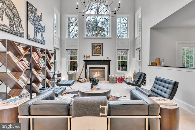 216 Pelagic Ln, Solomons, MD 20688 - living area featuring a high ceiling, baseboards, a chandelier, and a premium fireplace