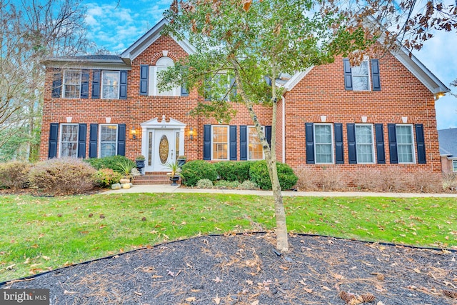 216 Pelagic Ln, Solomons, MD 20688 - view of front facade featuring a front yard and brick siding