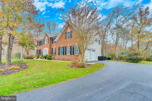 216 Pelagic Ln, Solomons, MD 20688 - colonial inspired home with brick siding, driveway, and a front yard