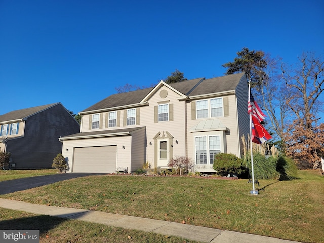 view of front of home with a garage and a front lawn