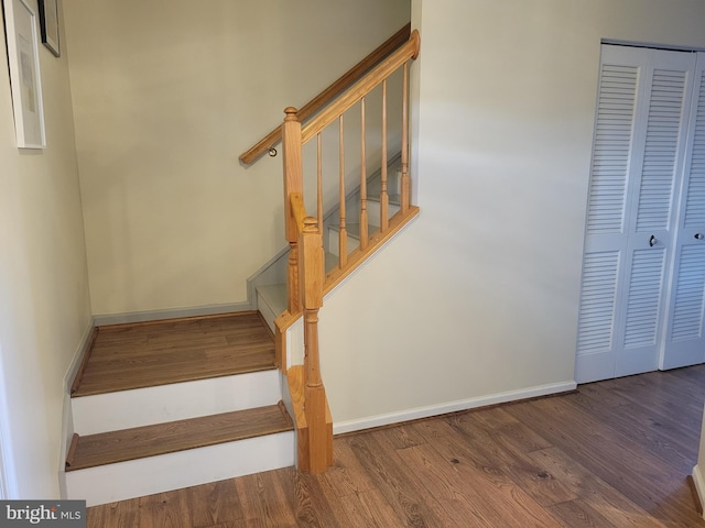 staircase with hardwood / wood-style flooring