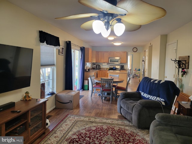 living room featuring light wood-type flooring and ceiling fan