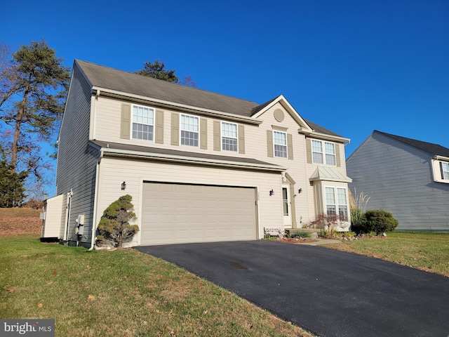 view of front facade with a garage and a front lawn