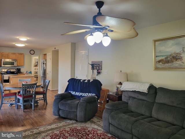 living room featuring dark hardwood / wood-style floors and ceiling fan