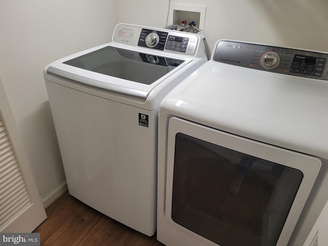 laundry room with washing machine and dryer and dark hardwood / wood-style flooring