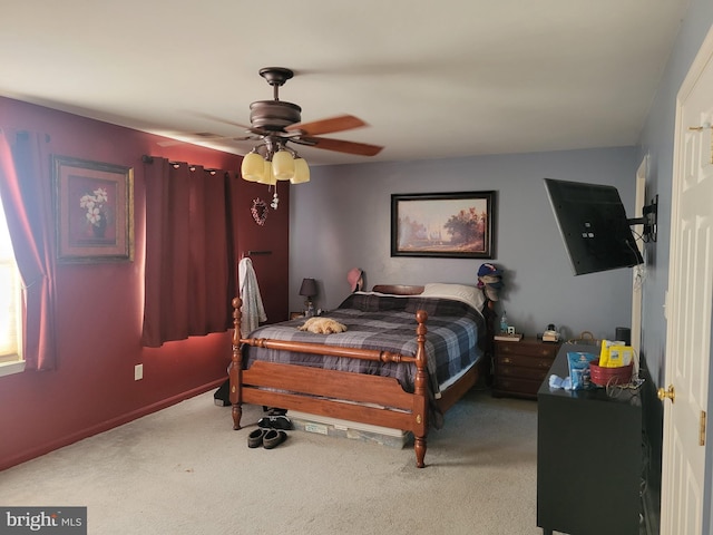 bedroom with ceiling fan and light carpet