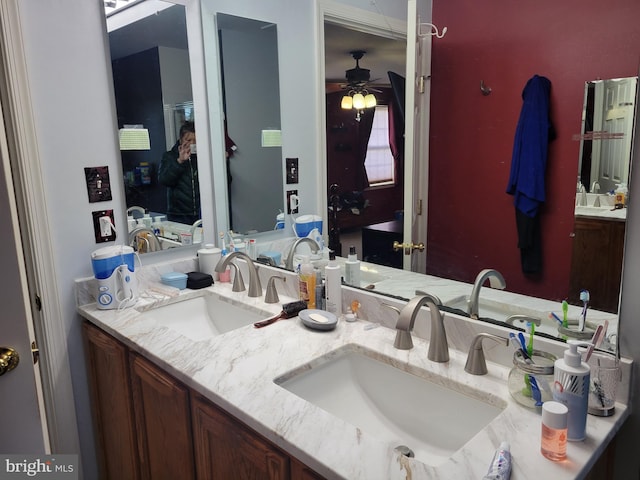 bathroom with ceiling fan and vanity