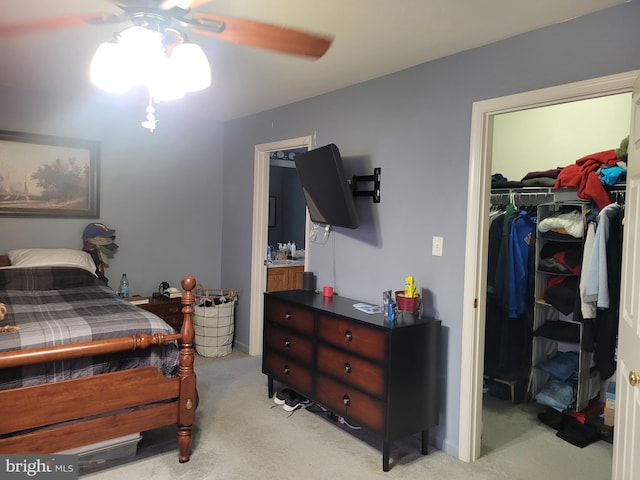 carpeted bedroom featuring ceiling fan and a closet