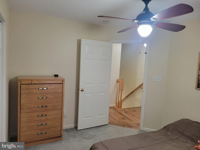 bedroom with ceiling fan and light carpet