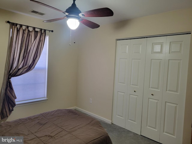 unfurnished bedroom featuring ceiling fan, light carpet, and a closet