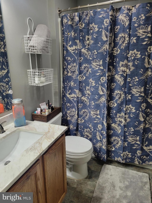 bathroom featuring tile patterned floors, vanity, and toilet