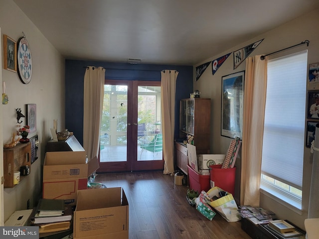 living area featuring french doors and dark wood-type flooring