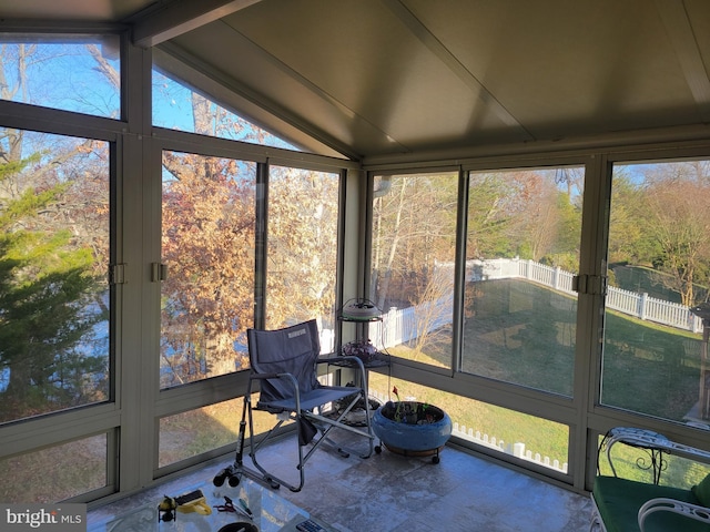 sunroom / solarium featuring lofted ceiling