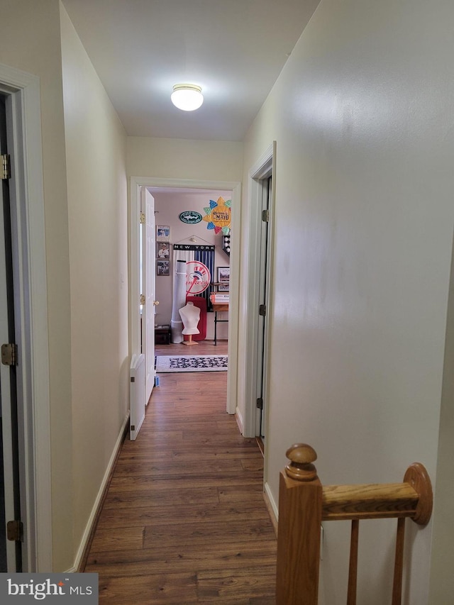 corridor with dark wood-type flooring and radiator