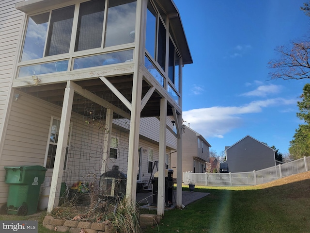 view of home's exterior with a patio and a lawn