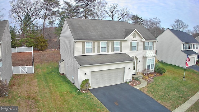 view of front of home featuring a garage and a front lawn