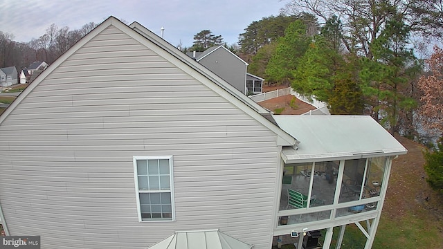 view of side of home featuring a sunroom