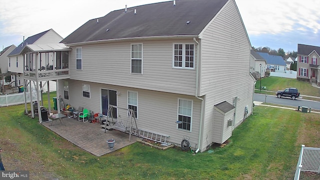 back of house featuring a yard and a patio