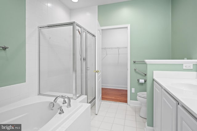 full bathroom featuring tile patterned floors, vanity, toilet, and independent shower and bath