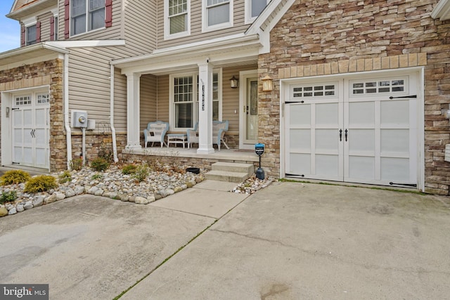 doorway to property with a porch and a garage