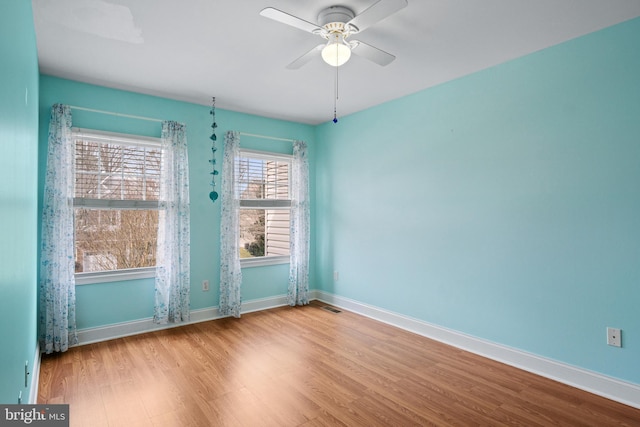 spare room with light wood-type flooring and ceiling fan