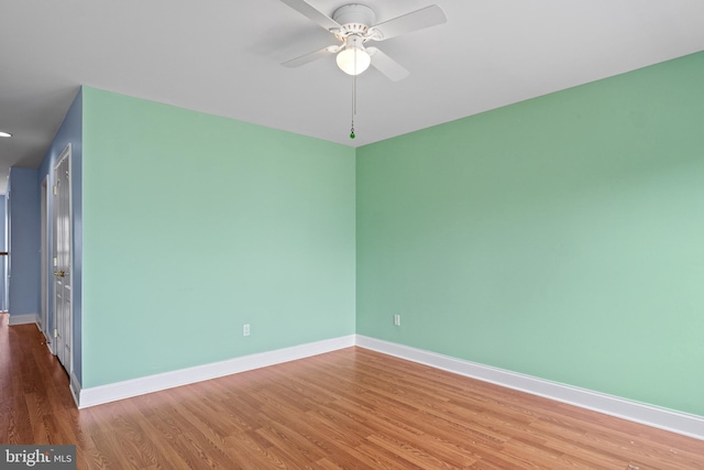 empty room featuring hardwood / wood-style floors and ceiling fan