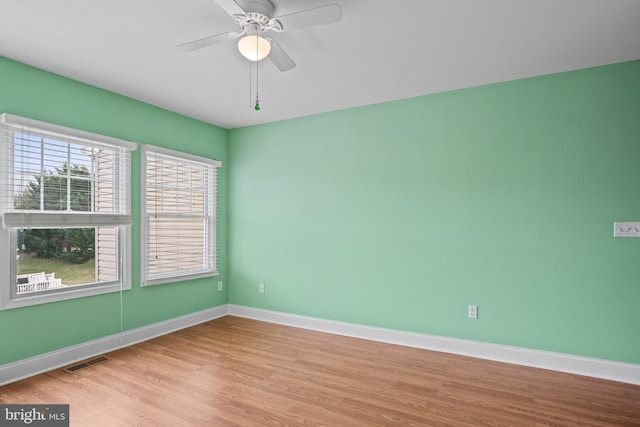 empty room with light hardwood / wood-style flooring and ceiling fan