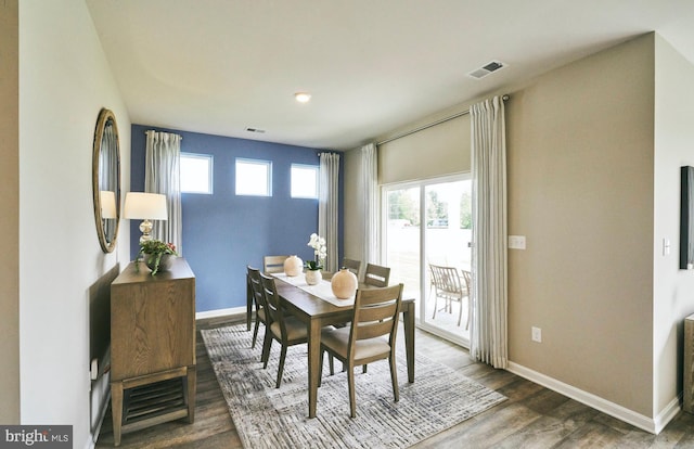 dining area with dark hardwood / wood-style flooring