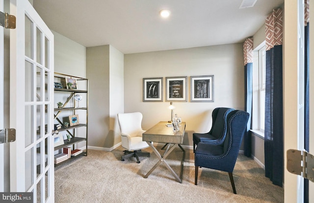 carpeted home office with french doors