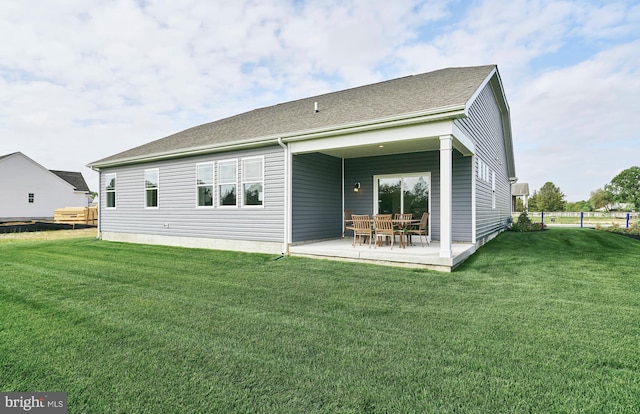 rear view of house with a patio area and a yard