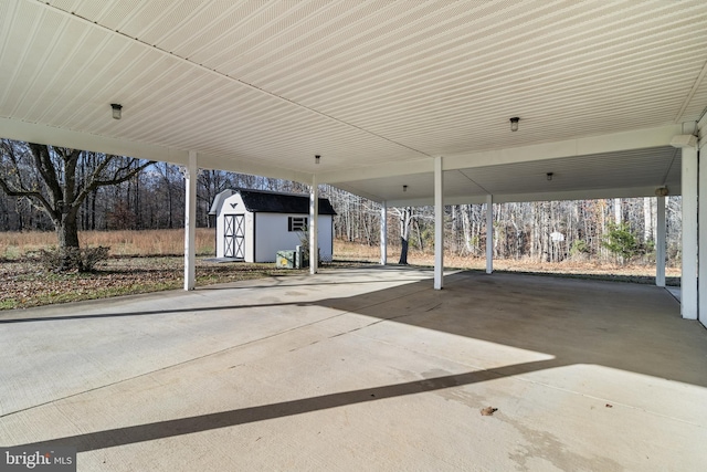 view of patio / terrace with a carport and a shed