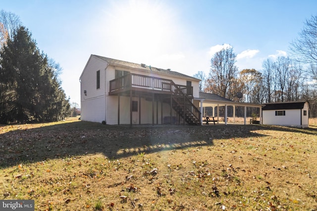 back of house featuring a storage unit, a yard, and a wooden deck