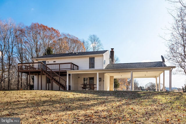 back of property featuring a yard and a deck