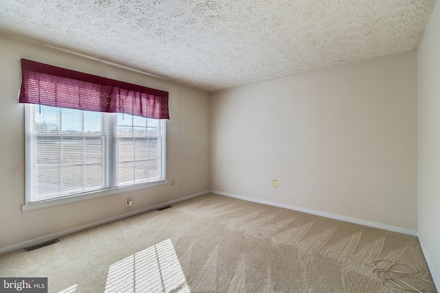 unfurnished room featuring a textured ceiling and carpet floors