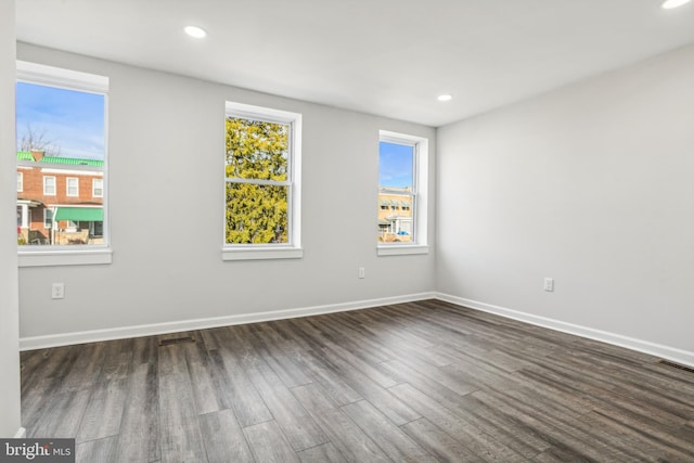 unfurnished room featuring dark wood-type flooring