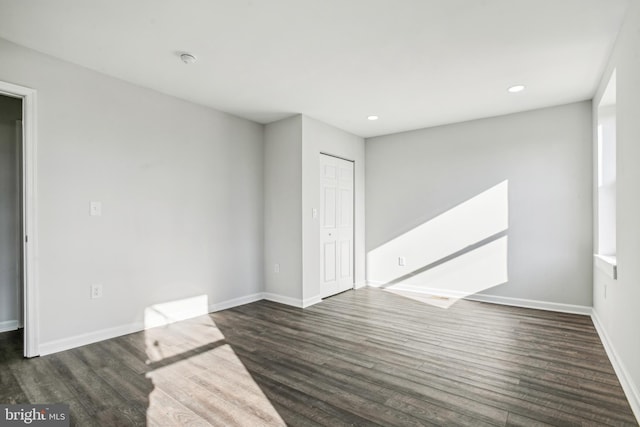 empty room with dark hardwood / wood-style floors