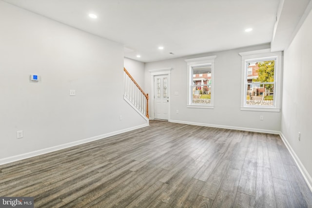 unfurnished living room with dark wood-type flooring