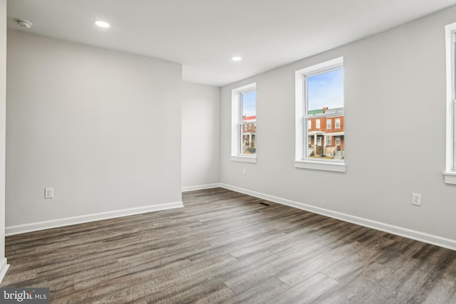 spare room with dark hardwood / wood-style flooring