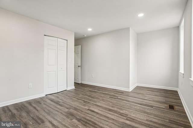 spare room with dark wood-type flooring