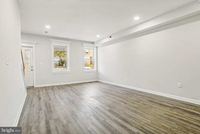 unfurnished room with hardwood / wood-style flooring