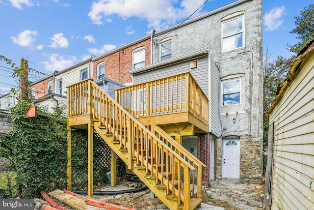 rear view of property featuring a deck